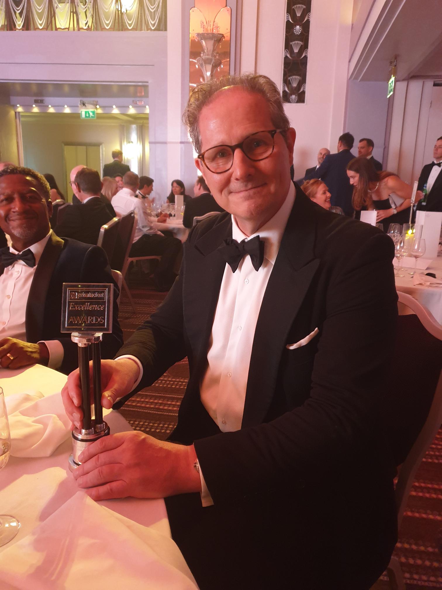 Grant Wilson, Chief Investment Officer holding ARC's 2023 eprivateclient Excellence Award